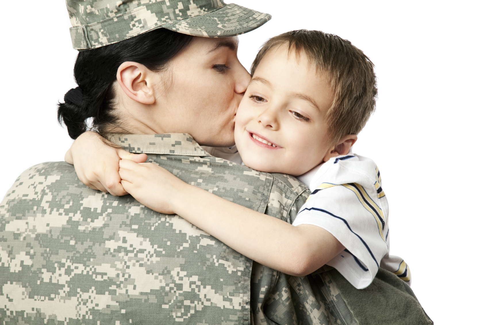 Female veteran in uniform kissing child on the cheek.